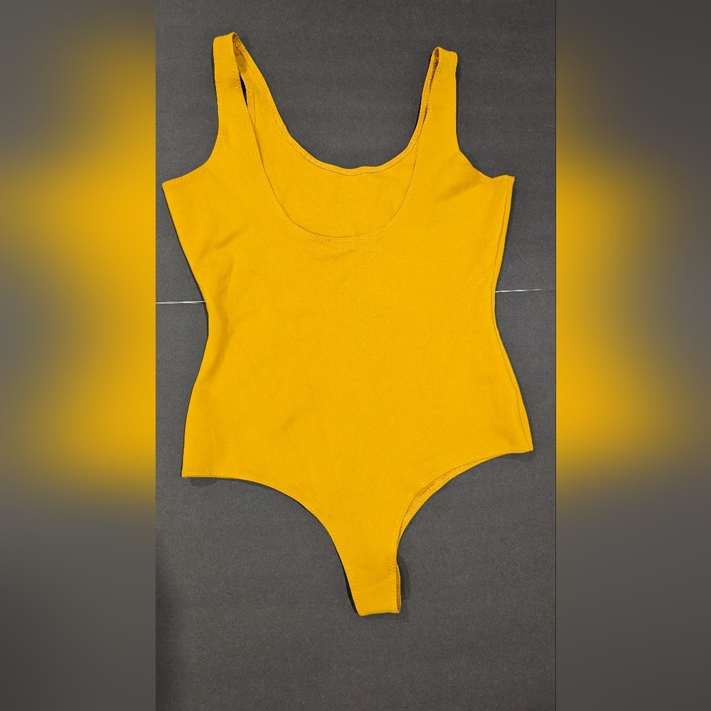 Shinestar yellow bodysuit new. Large